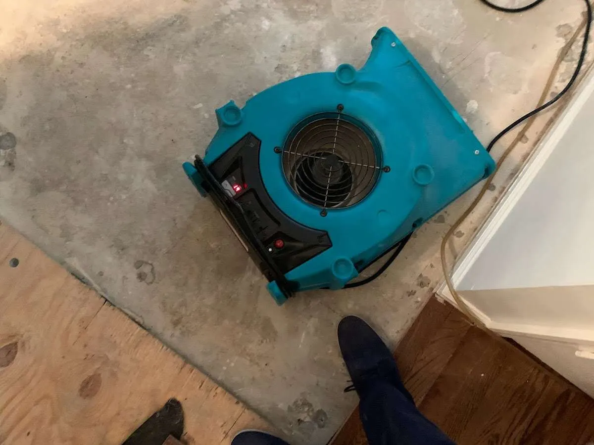 Air mover drying subfloor during Commercial Water Damage Restoration in Riverton